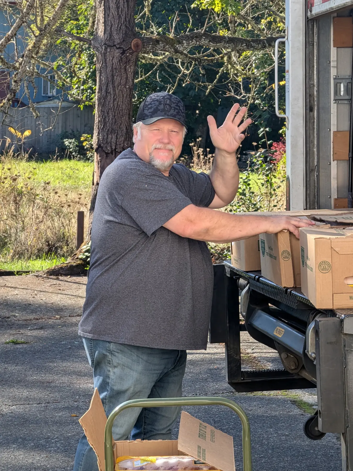 GG's House volunteer moving boxes of practical supplies during community service work