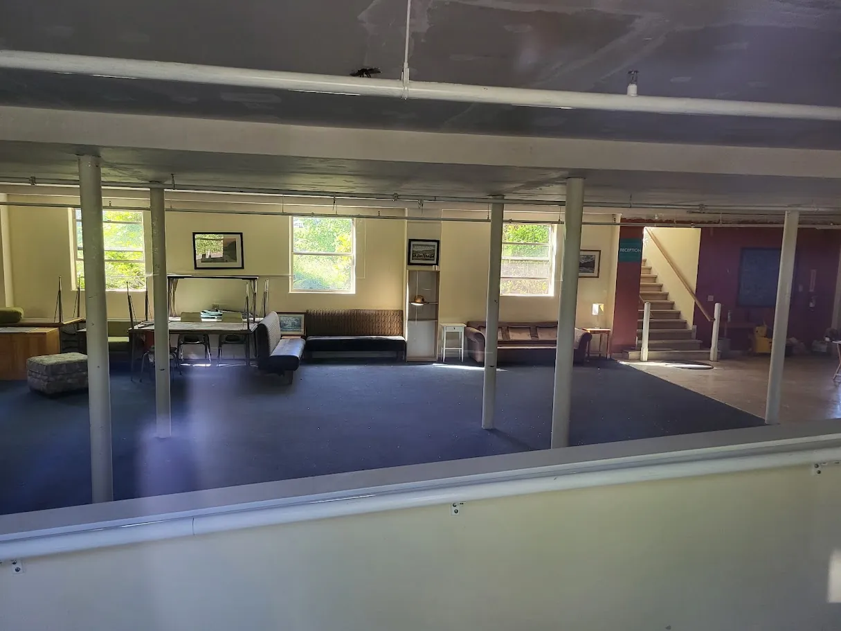 Current community room interior with daylight and open floor area
