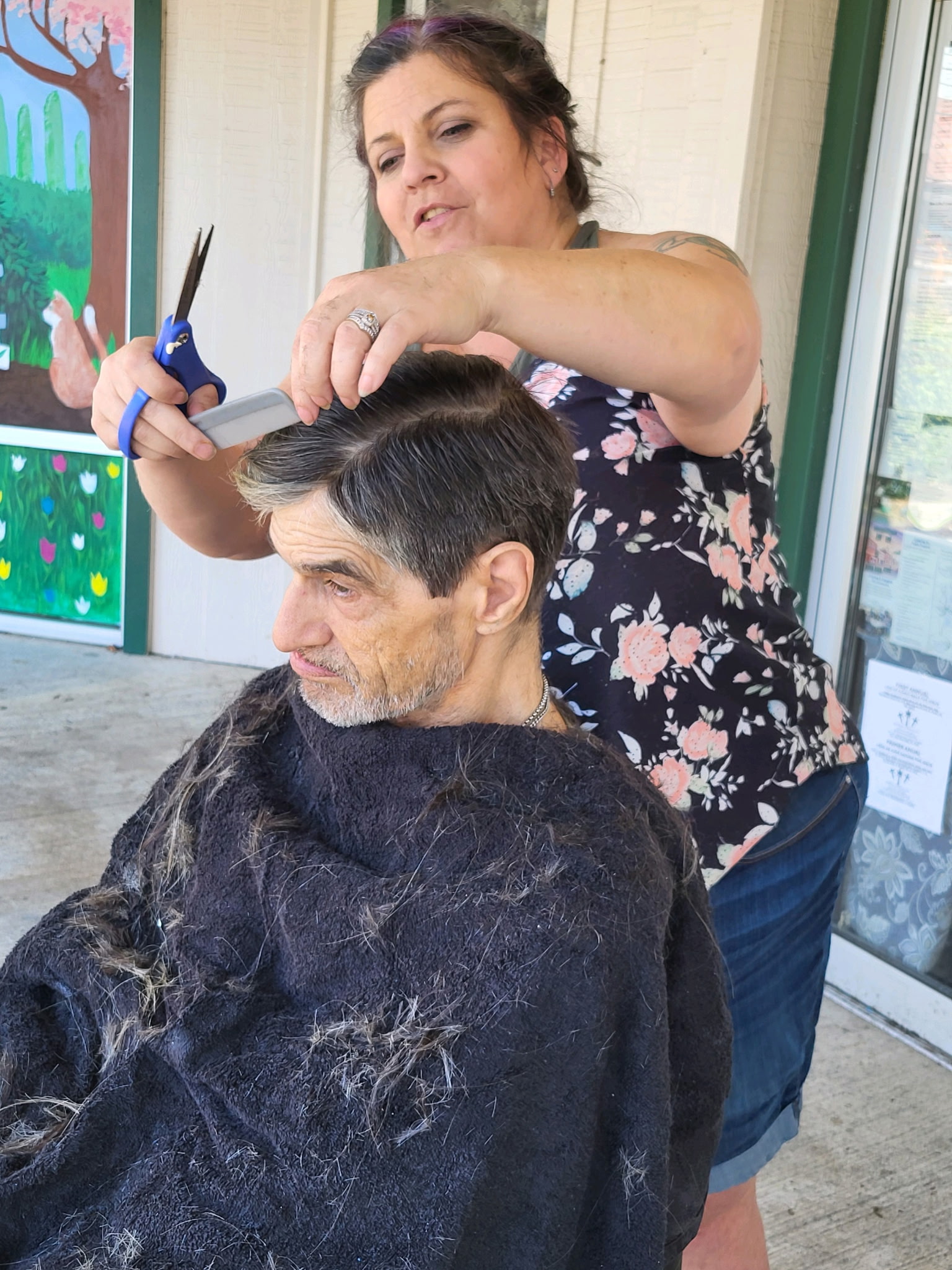 Angel cutting hair outside GG's House