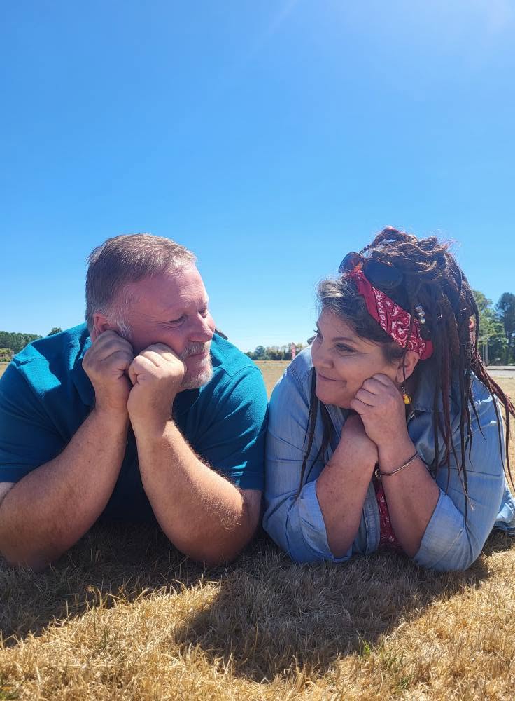 Steve and Angel looking at each other in a field